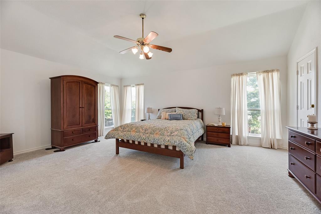 1406 West Peters Colony Road Carrollton, TX 75007 - Photo 9 of 29 a spacious bedroom with a bed a window and closet