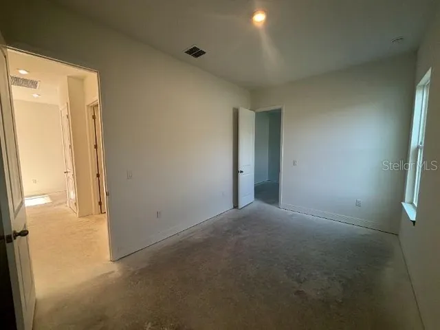 a view of an empty room and closet area