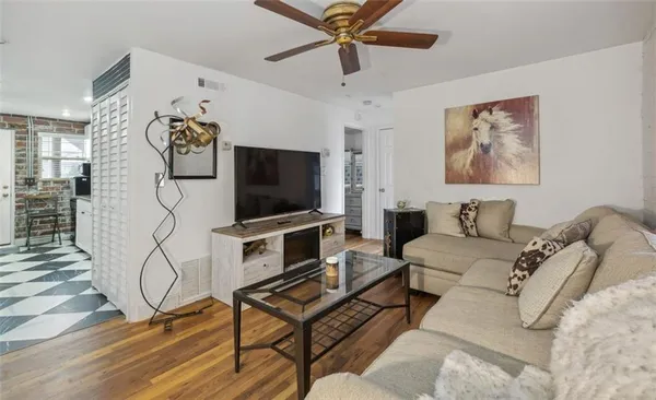 a living room with furniture a rug and a flat screen tv
