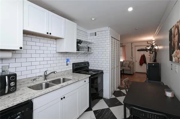 a kitchen with a sink appliances and cabinets