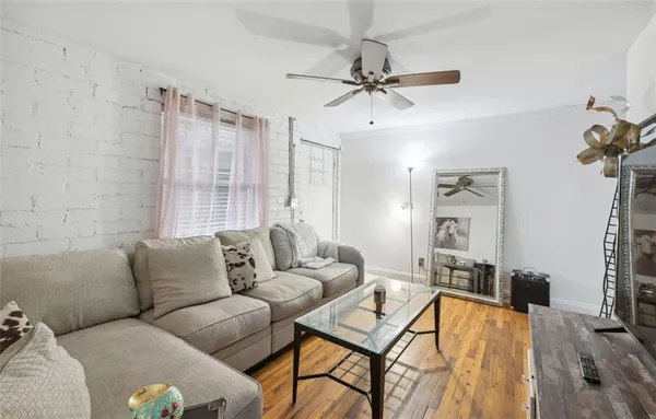 a living room with furniture and a wooden floor