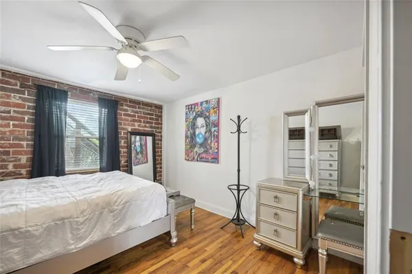 a bedroom with a bed and large window