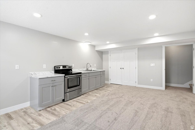 2973 West Red Sand Rd Haven Ogden, UT 84401 - Photo 17 of 30 Kitchenette featuring a stainless steel range, light grey cabinetry, and stone-finish countertops