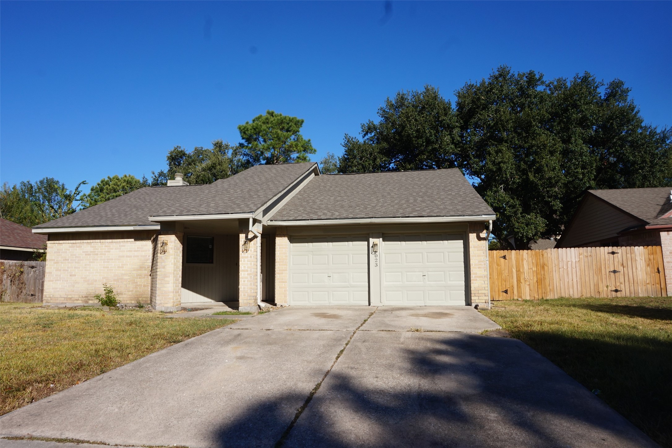 6023 Woodmancote Drive Humble, TX 77346 - Photo 1 of 12 a front view of a house with a yard and garage