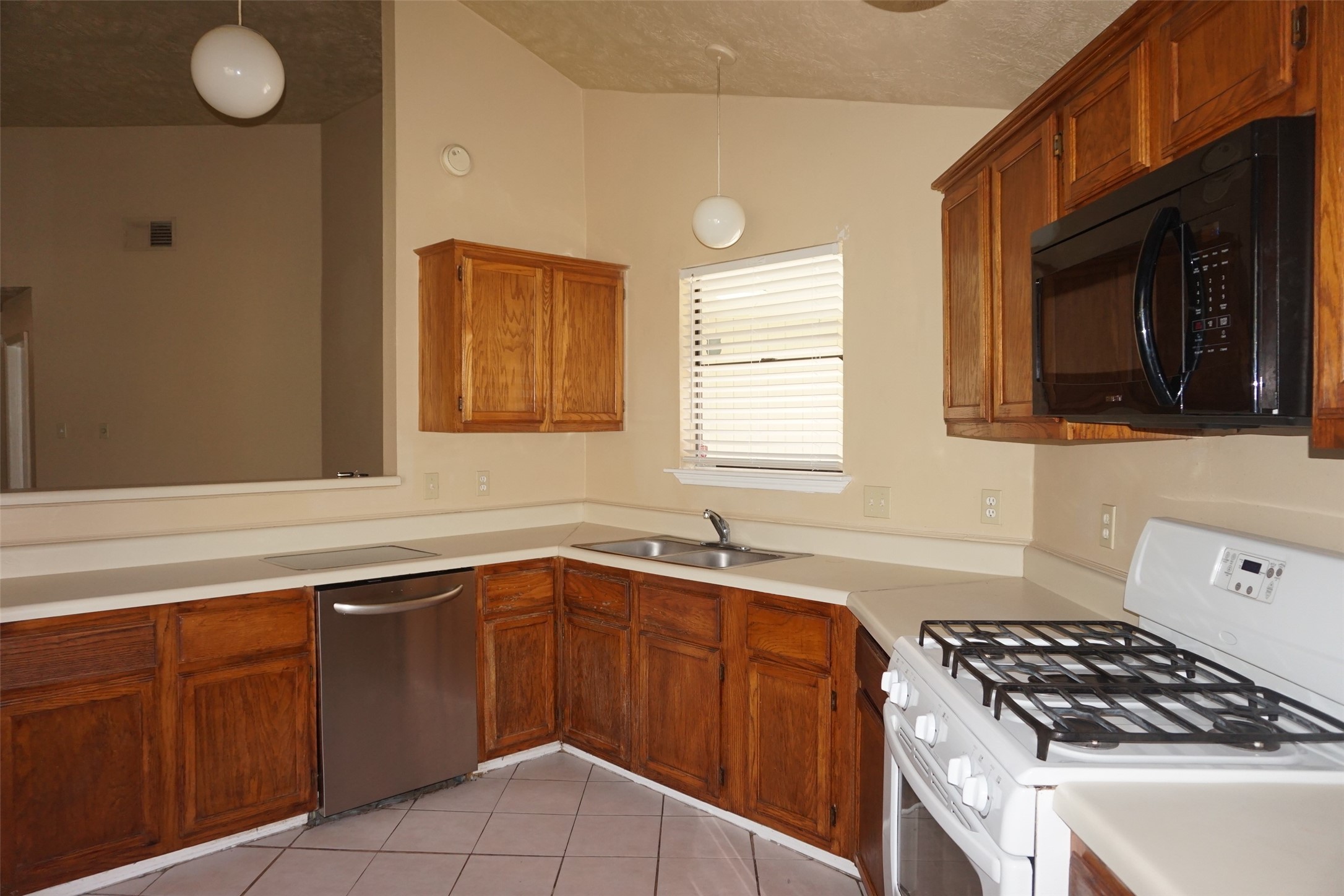 6023 Woodmancote Drive Humble, TX 77346 - Photo 5 of 12 a kitchen that has a sink and a stove