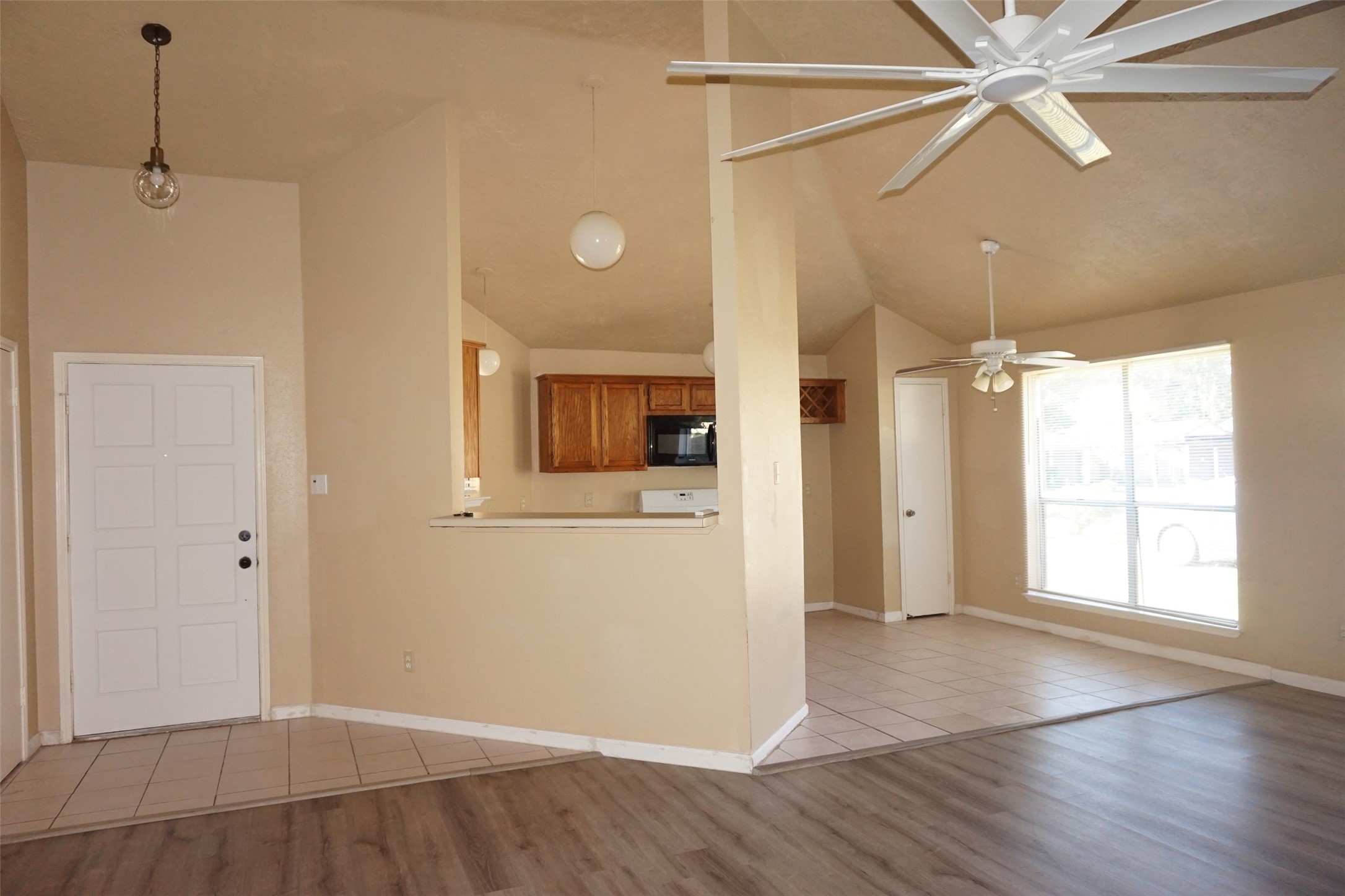 6023 Woodmancote Drive Humble, TX 77346 - Photo 7 of 12 a view of a livingroom with wooden floor and a ceiling fan