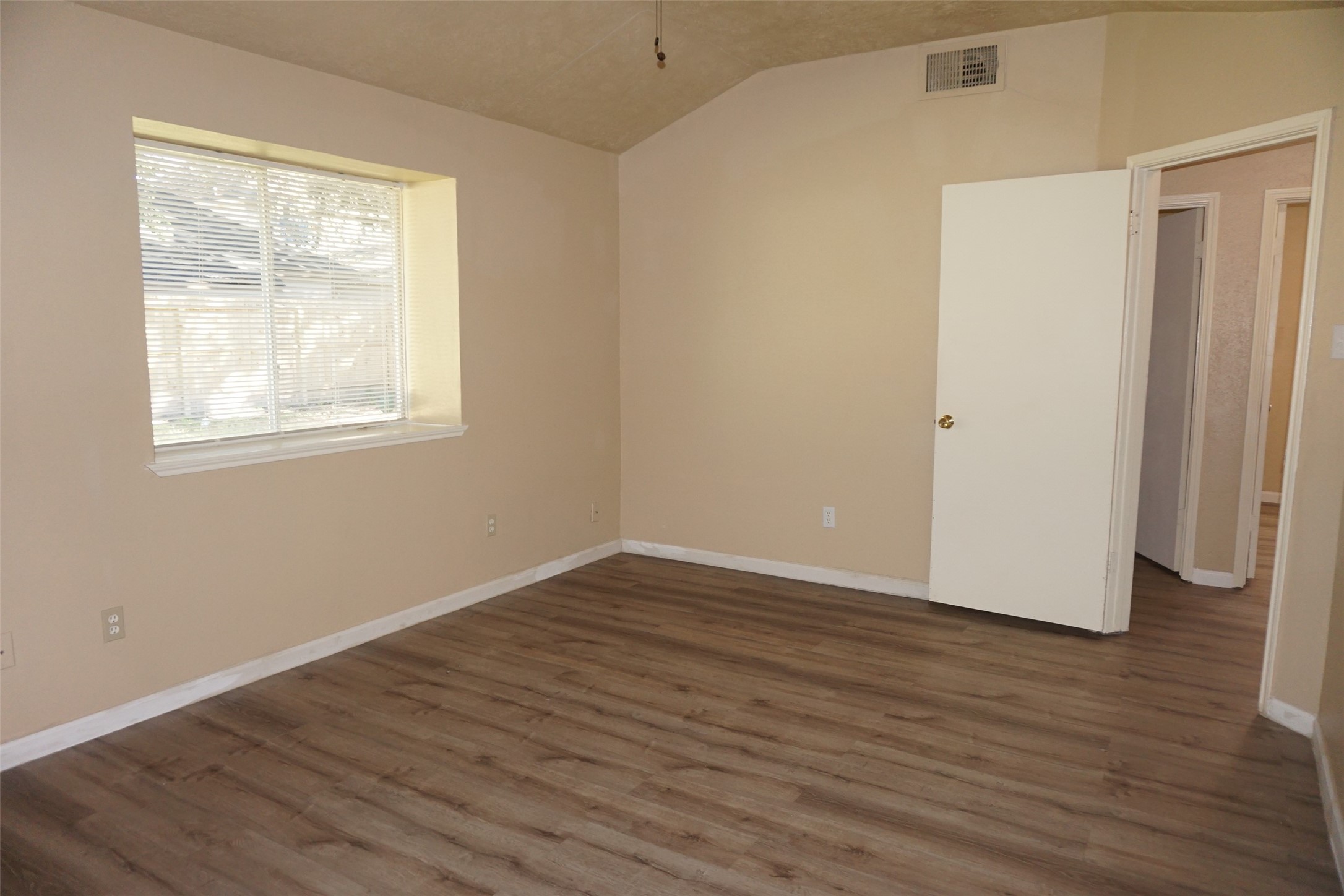 6023 Woodmancote Drive Humble, TX 77346 - Photo 9 of 12 an empty room with wooden floor and windows