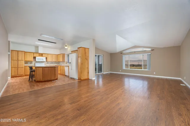 a view of a kitchen with a sink and a refrigerator