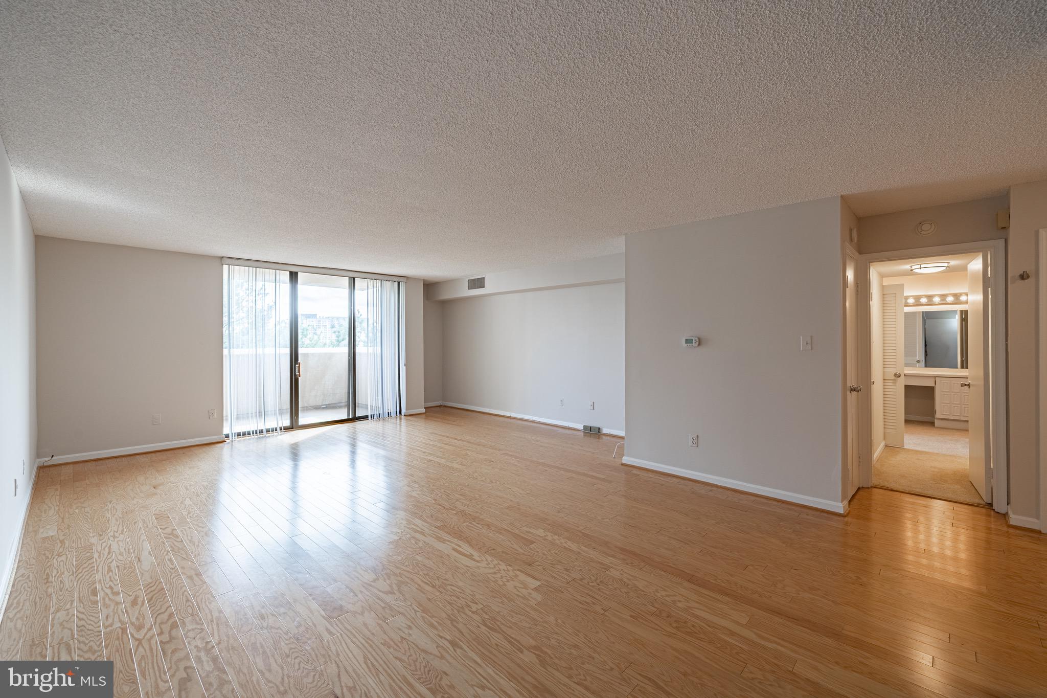 1101 South Arlington Ridge Road, Unit 704 Arlington, VA 22202 - Photo 27 of 70 a view of an empty room with window and wooden floor
