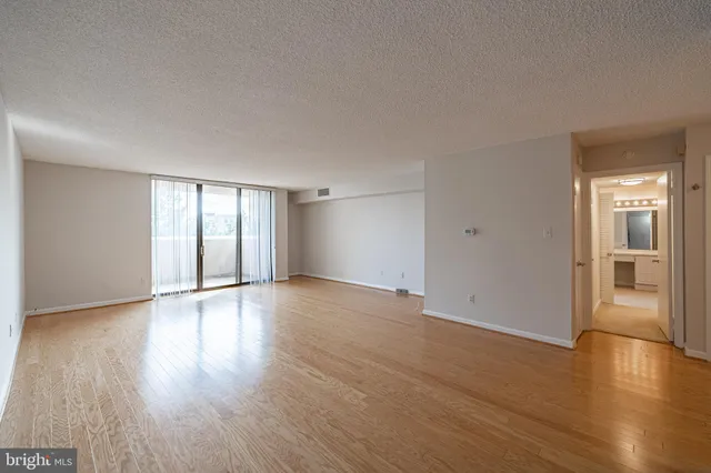 a bathroom with a granite countertop sink a mirror and shower