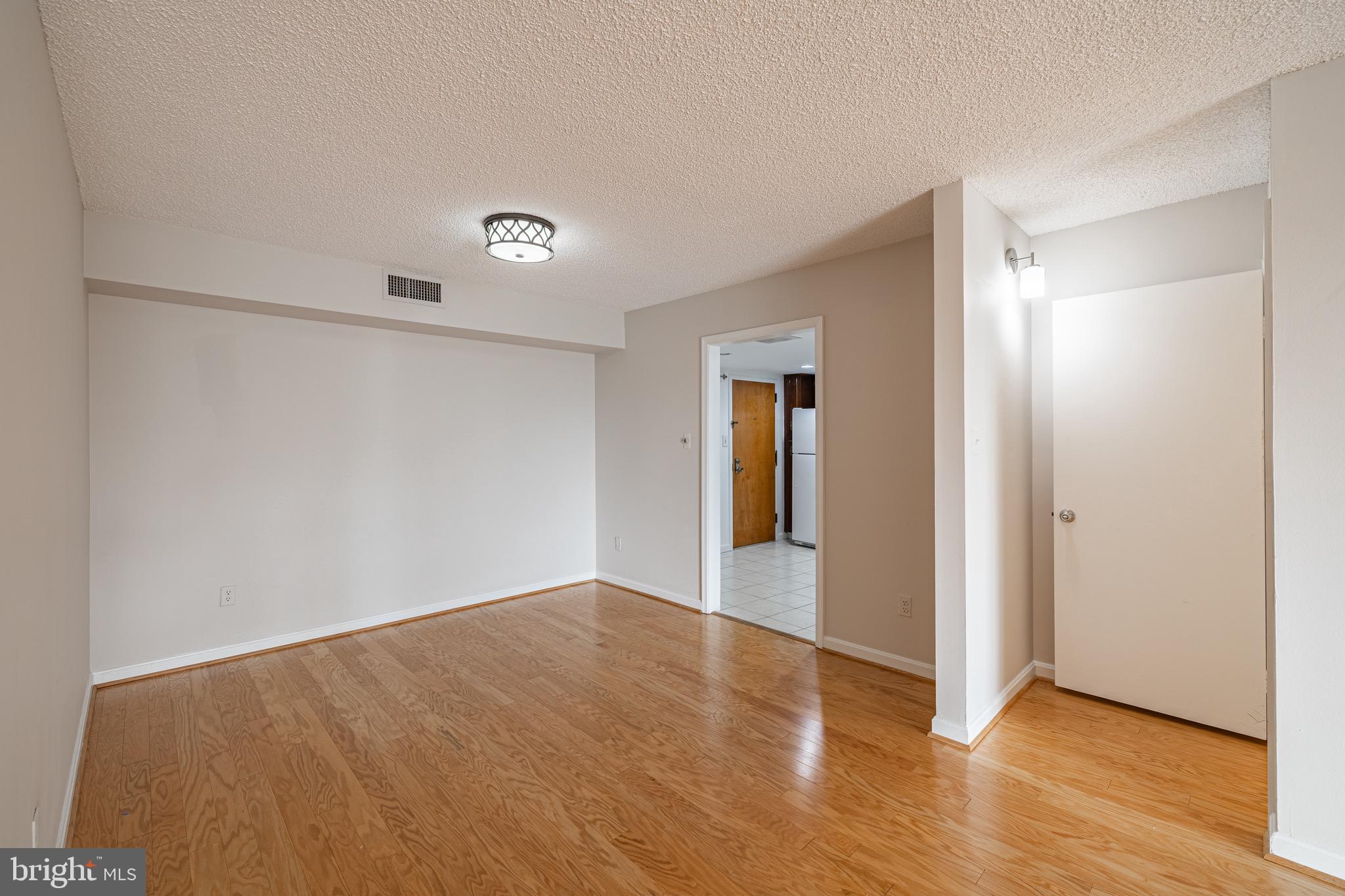 1101 South Arlington Ridge Road, Unit 704 Arlington, VA 22202 - Photo 29 of 70 a view of an empty room with wooden floor and a window