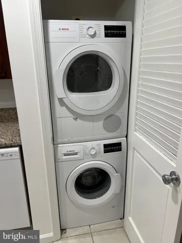 a view of a patio with a table and chairs under an umbrella