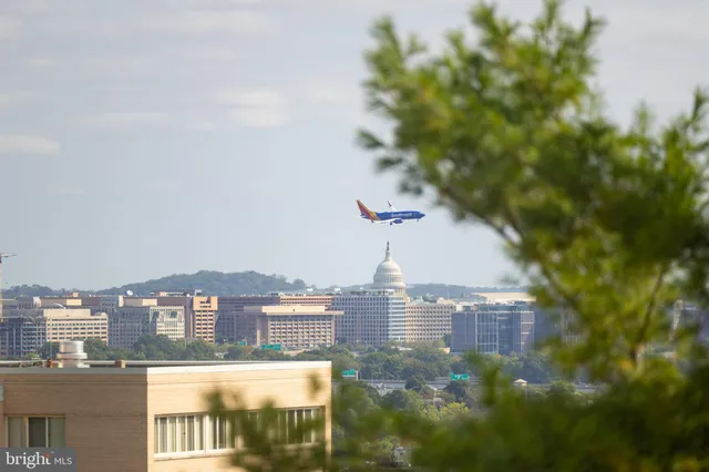 a living room filled with furniture and a large window