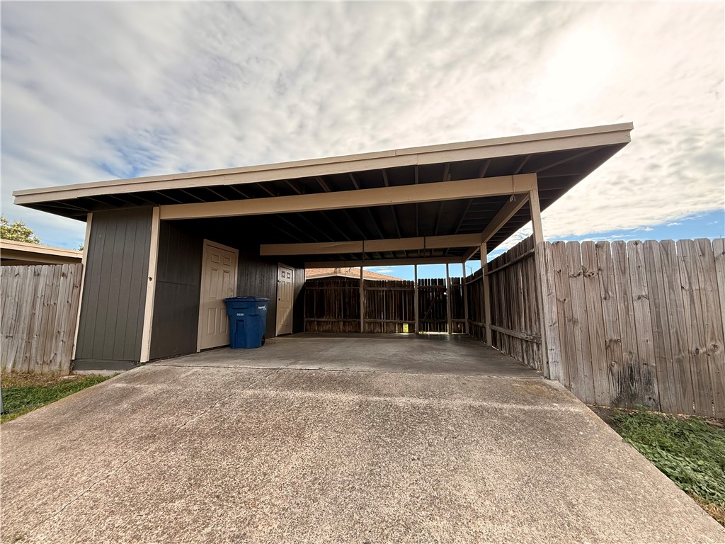 5018 Wingfoot Lane, Unit A Corpus Christi, TX 78413 - Photo 13 of 13 a view of backyard with large trees and wooden fence