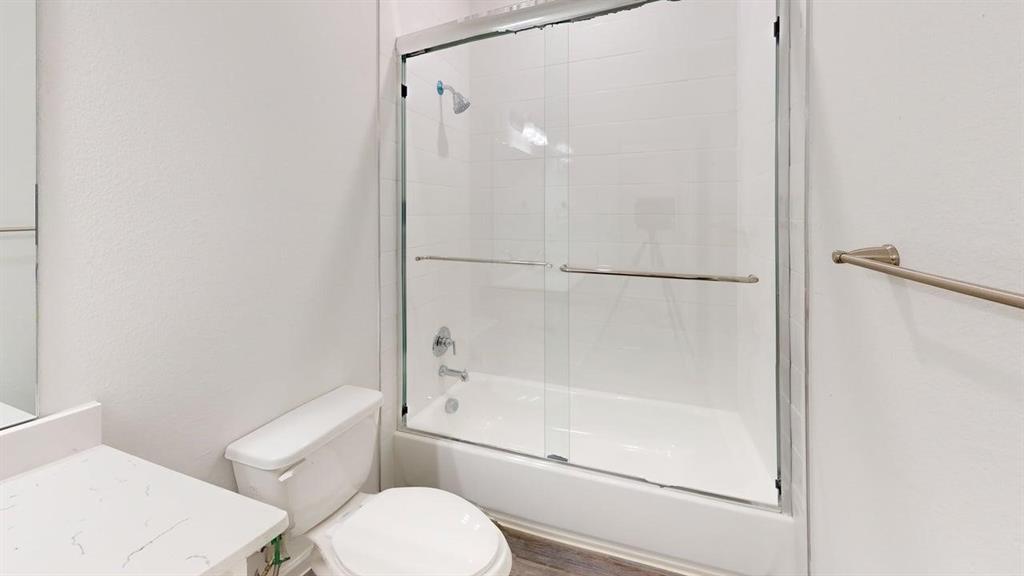 285 Buck Ridge Drive Frisco, TX 75068 - Photo 18 of 20 Full bath with vanity, enclosed tub / shower combo, and a textured wall