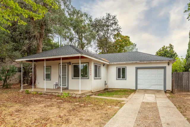 a front view of a house with a garden