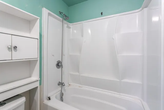 a bathroom with a bathtub and a shower