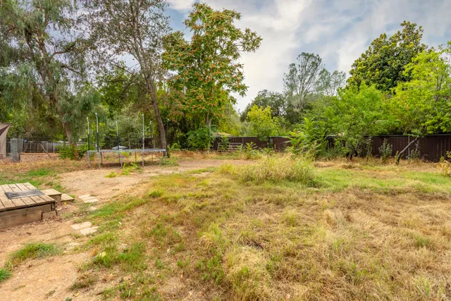 a swimming pool with trees in the background
