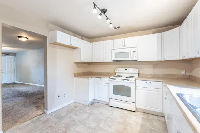 a kitchen with cabinets appliances and a sink