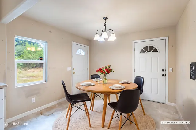 a view of a dining room with furniture wooden floor and a chandelier