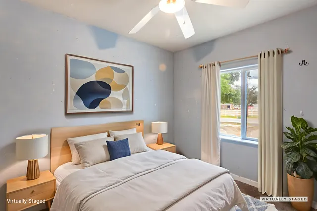 a bedroom with a bed and a painting on the wall