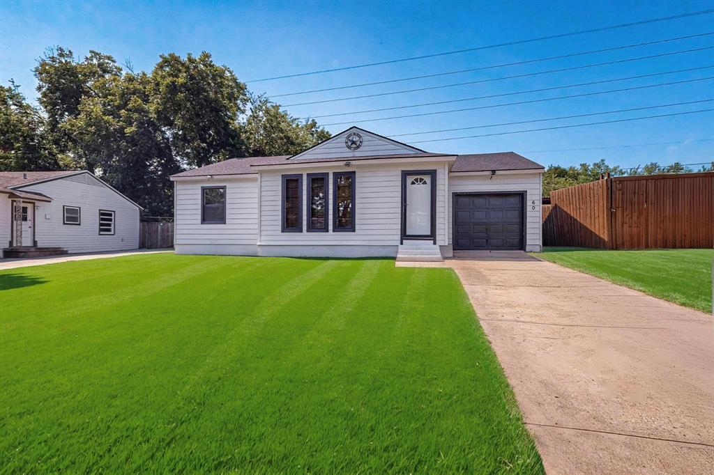a front view of a house with yard and green space