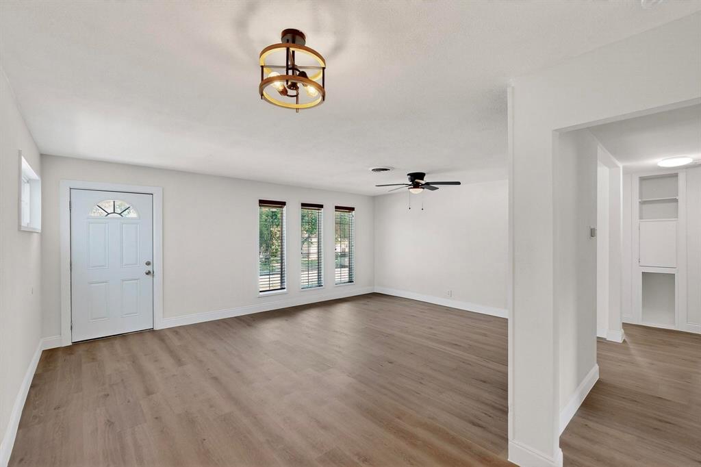 1609 Biggs Terrace Arlington, TX 76010 - Photo 11 of 18 wooden floor in an empty room with a window
