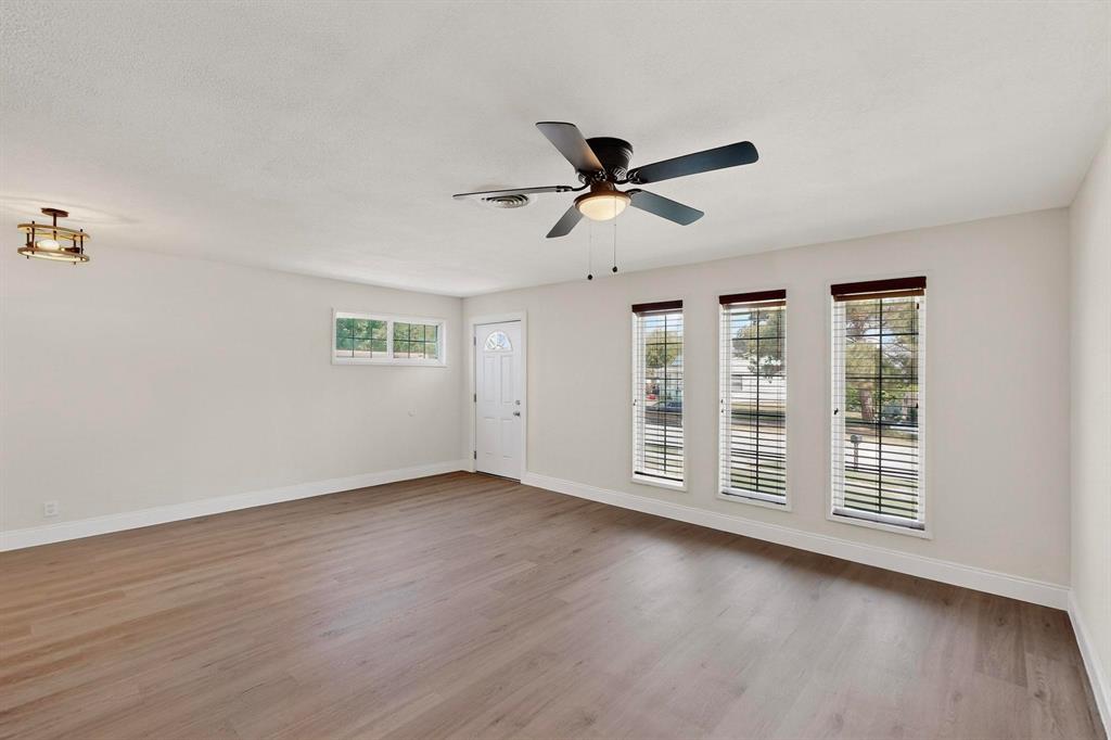 1609 Biggs Terrace Arlington, TX 76010 - Photo 7 of 18 a view of a livingroom with wooden floor and a ceiling fan