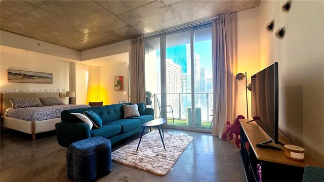 a living room with furniture gym equipment and a large window