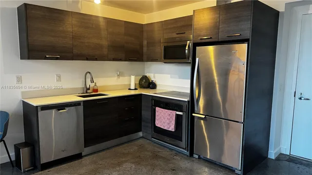a kitchen with a refrigerator and a sink