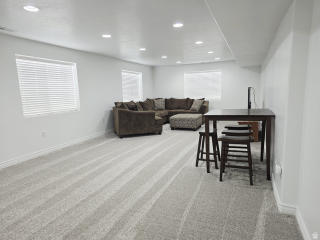 1437 925 South Vernal, UT 84078 - Photo 21 of 47 Spacious room featuring light gray carpeting, recessed lighting, white trim, and multiple windows with blinds
