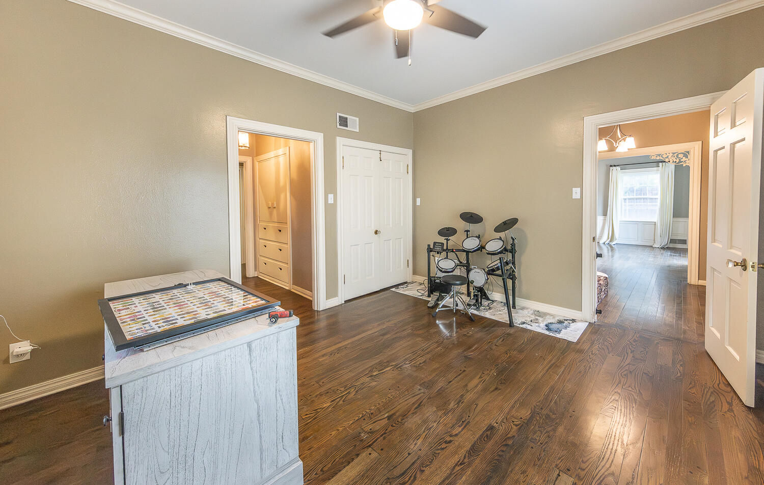 5104 19th Street Lubbock, TX 79407 - Photo 22 of 64 a view of workspace with wooden floor and chandelier fan