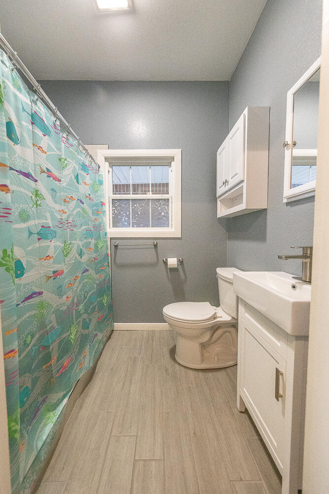 5104 19th Street Lubbock, TX 79407 - Photo 23 of 64 a bathroom with a sink a toilet and shower