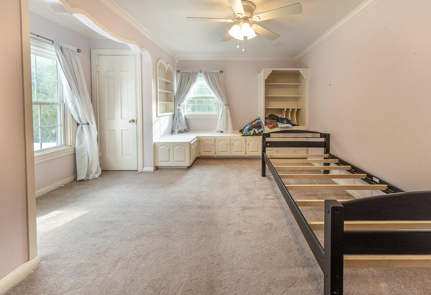 5104 19th Street Lubbock, TX 79407 - Photo 39 of 64 a living room with a bed furniture and a large window