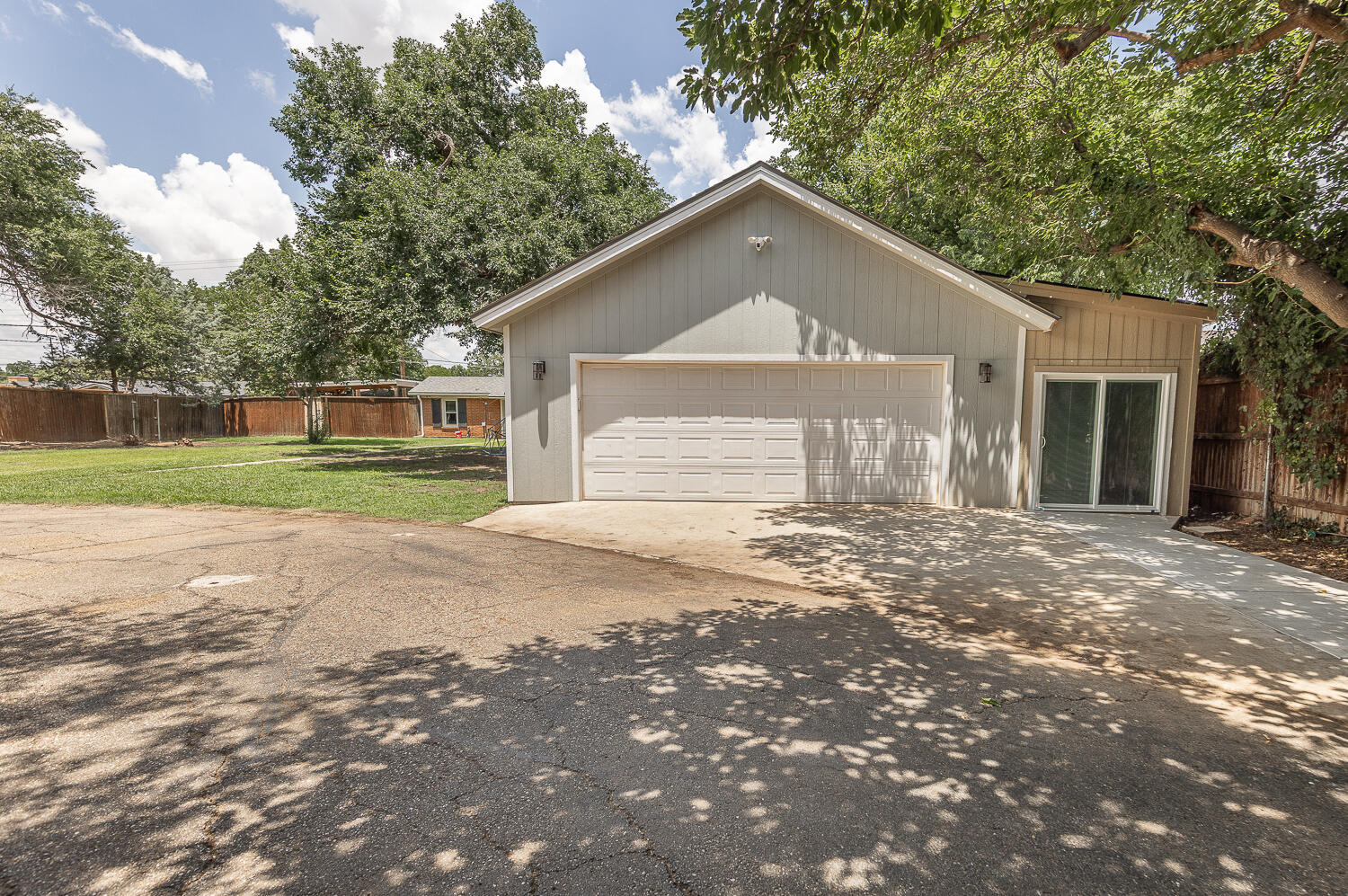 5104 19th Street Lubbock, TX 79407 - Photo 47 of 64 a front view of a house with a yard and garage