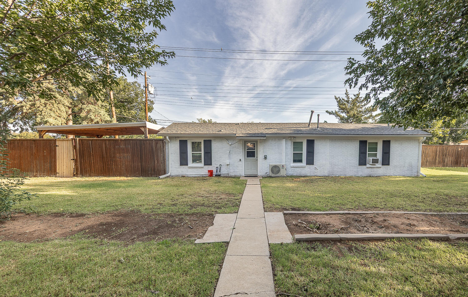 5104 19th Street Lubbock, TX 79407 - Photo 56 of 64 a front view of a house with a yard and a porch