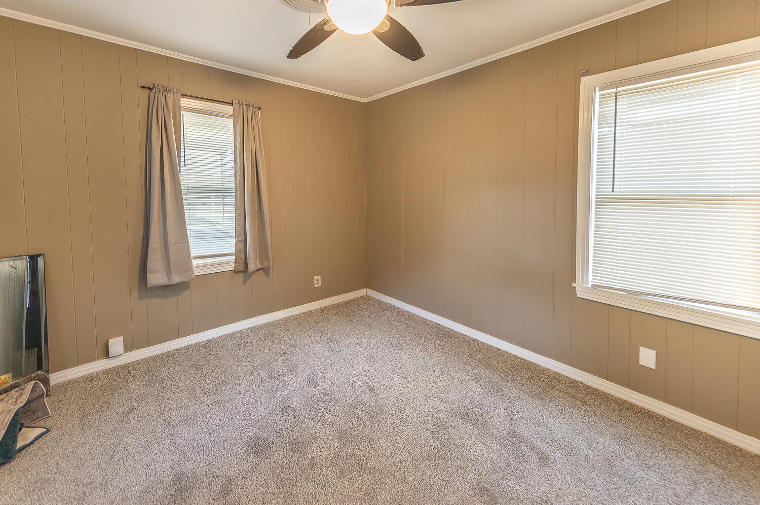5104 19th Street Lubbock, TX 79407 - Photo 57 of 64 an empty room with a window and a ceiling fan