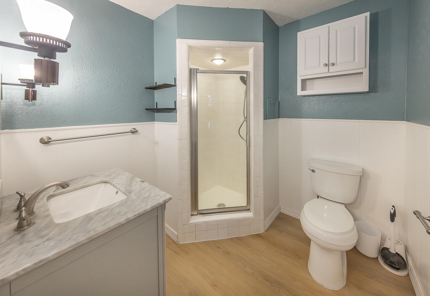 5104 19th Street Lubbock, TX 79407 - Photo 59 of 64 a bathroom with a granite countertop toilet sink and mirror