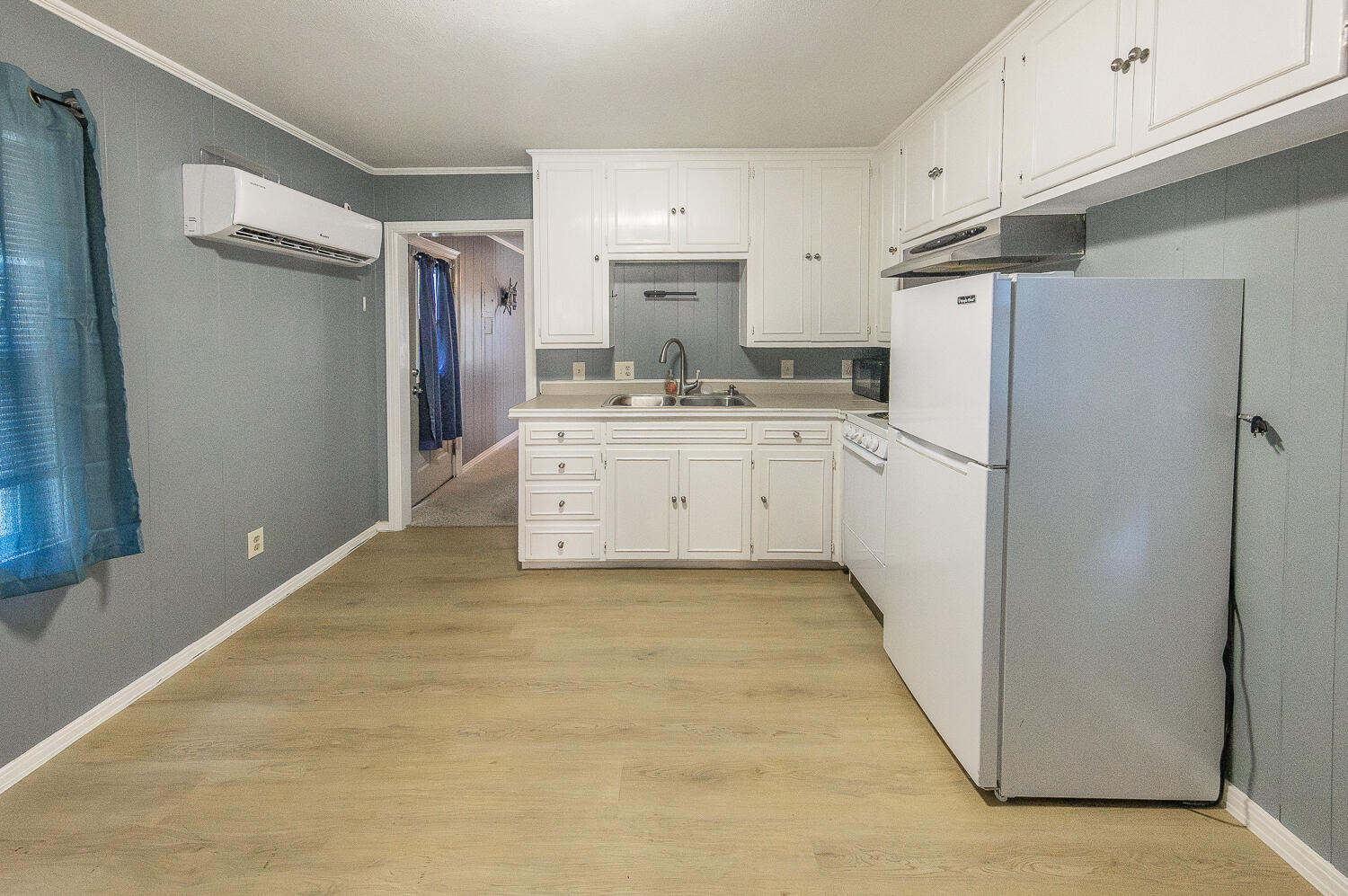 5104 19th Street Lubbock, TX 79407 - Photo 62 of 64 a kitchen with refrigerator and cabinets