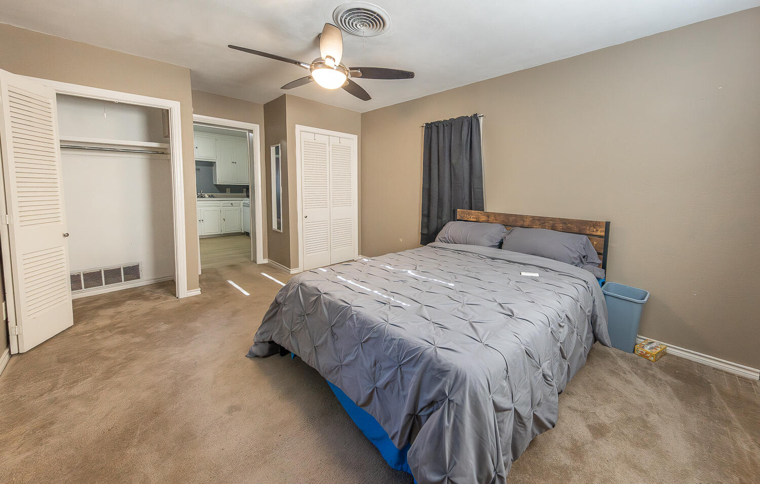 5104 19th Street Lubbock, TX 79407 - Photo 64 of 64 a bedroom with a bed and a ceiling fan