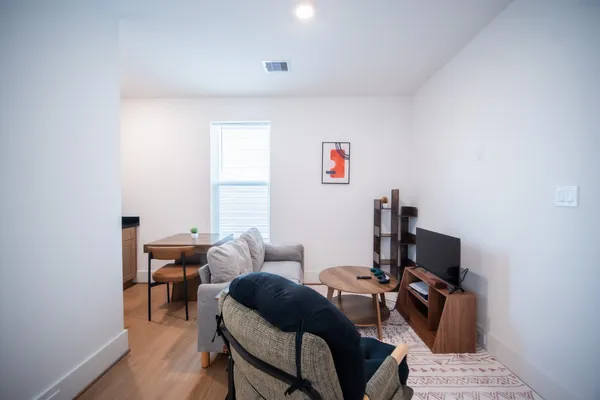 a bedroom with furniture and a window