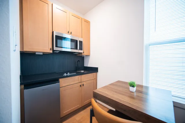 a kitchen with stainless steel appliances a stove microwave and sink