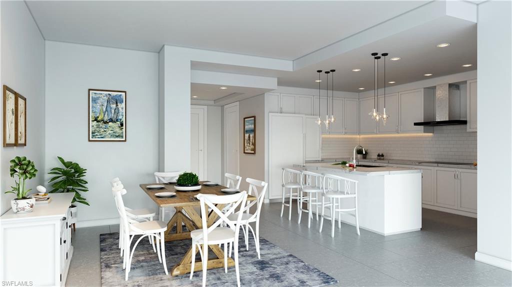 a kitchen with stainless steel appliances kitchen island granite countertop a dining table chairs and sink