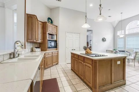 a kitchen with a sink stove and cabinets