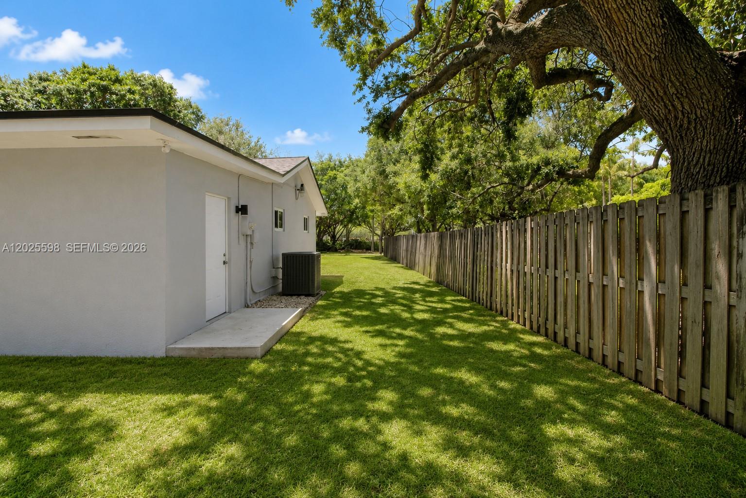 9421 Southwest 150th Street Miami, FL 33176 - Photo 25 of 31 a backyard of a house with plants and tree