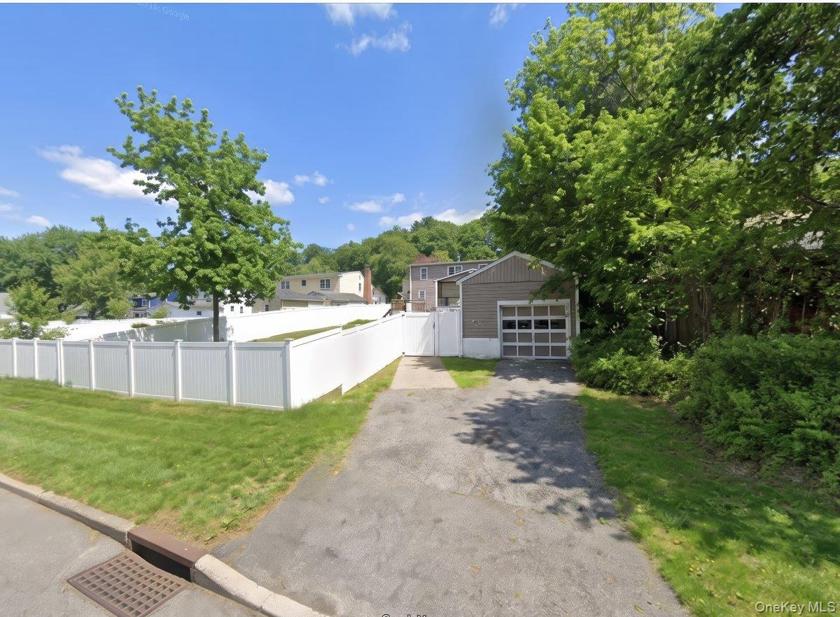 10 Susquehanna Road Ossining, NY 10562 - Photo 27 of 31 Detached garage with horizontal siding and paneled garage door