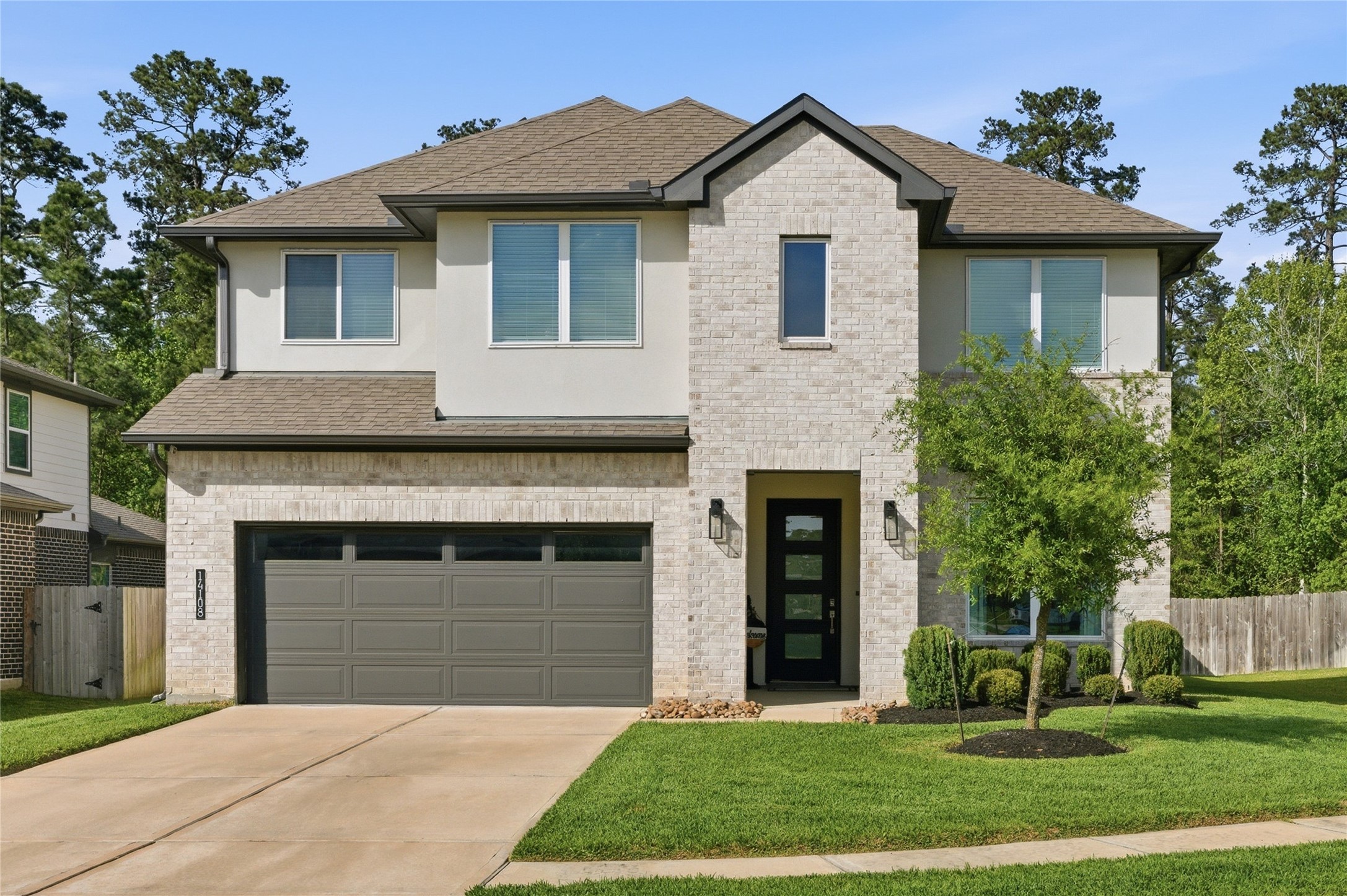14108 Redfish Lake Conroe, TX 77384 - Photo 1 of 37 a front view of a house with a yard and garage