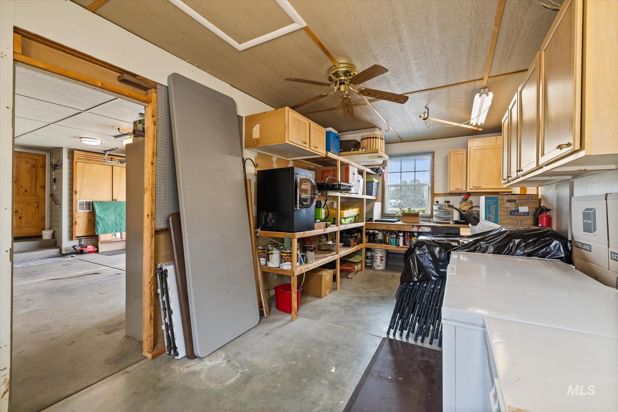 1140 Edgemont Road Emmett, ID 83617 - Photo 48 of 50 Utility space featuring a window, built-in cabinetry, overhead lighting, and a ceiling fan