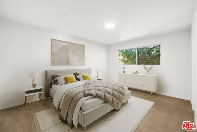 a bedroom with a bed and a couch