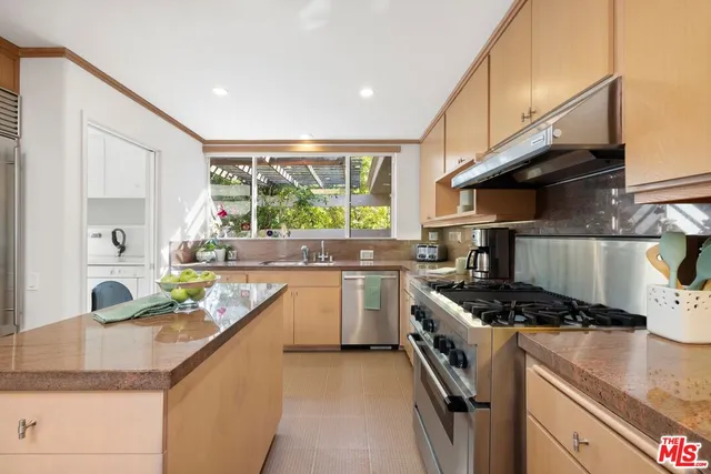 a kitchen with stove a sink and cabinets